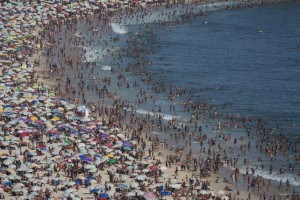 Thousands of beach goers pack Ipanema beach in Rio de Janeiro, Brazil, Sunday, Dec. 28, 2014. With temperatures reaching over 40 degrees celsius,Rio beaches were packed on the last weekend of the year.